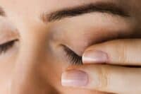Woman touching her sore eyes, Meibomian Gland Dysfunction